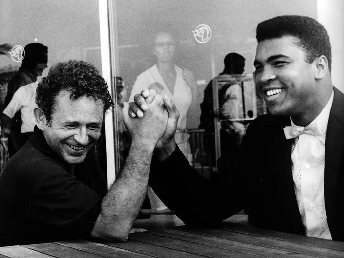 Norman Mailer arm-wrestling Muhammad Ali in San Juan, late July 1965